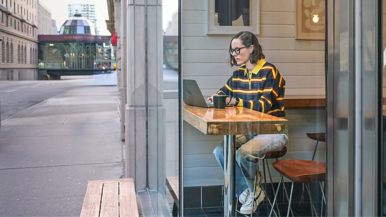 Chantelle Little, Founder of Tiller, on her laptop at a coffee shop